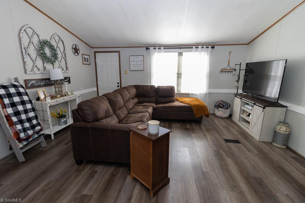 8280 Stafford Mill Road Oak Ridge, NC 27310 - Photo 13 of 40 THIS HOME FEATURES VAULTED CEILINGS, VINYL PLANK WOOD LOOK FLOORS