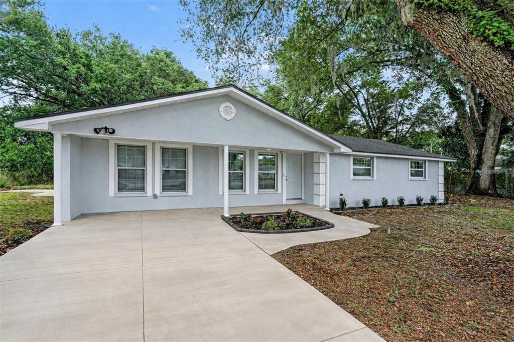7310 Fort King Road Zephyrhills, FL 33541 - Photo 1 of 1 a front view of a house with garden
