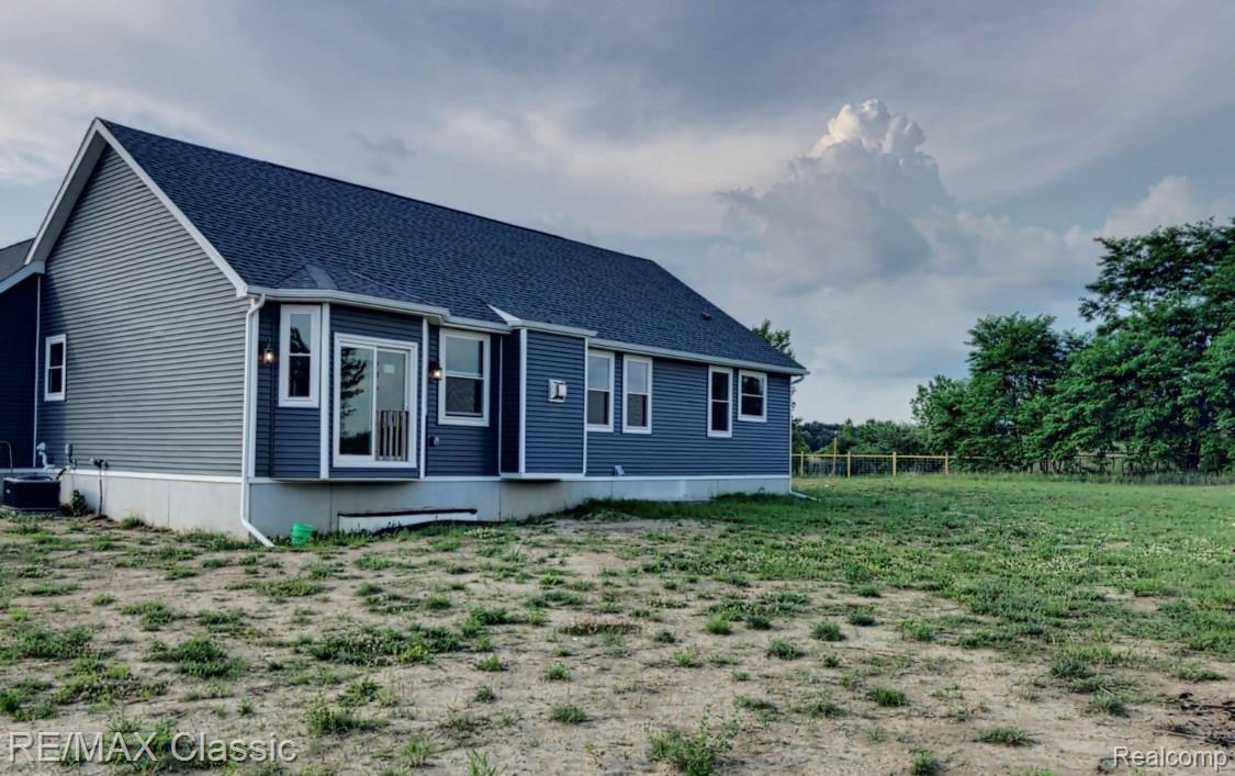 2816 Fisher Road Howell, MI 48855 - Photo 3 of 38 The rear view of the home