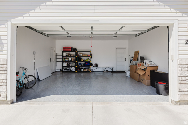 287 East 1000 North Logan, UT 84321 - Photo 5 of 41 Attached two-car garage featuring a speckled epoxy floor and recessed lighting