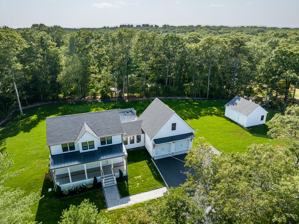 an aerial view of a house with swimming pool garden view and trees
