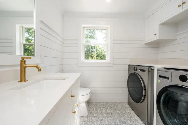 a bathroom with a sink a washer and dryer