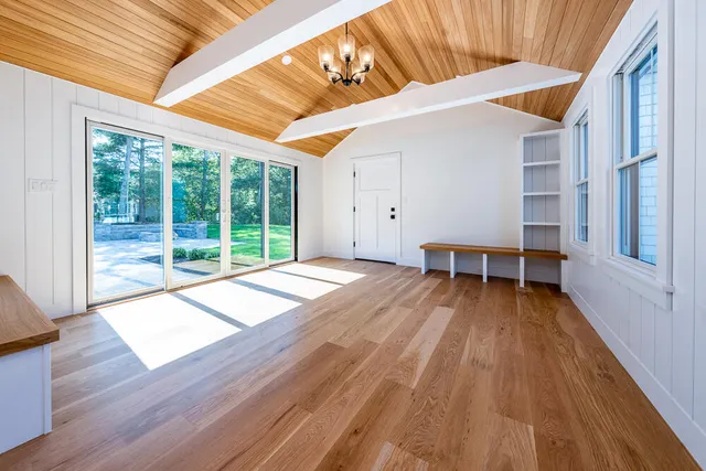 a view of a backyard with wooden floor and fence