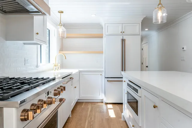 a kitchen with granite countertop a stove and a refrigerator