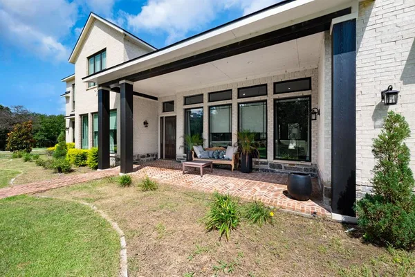 a view of a house with backyard sitting area and garden