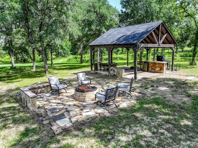 a view of a house with backyard sitting area and garden