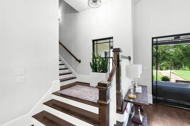 a view of entryway with wooden floor and windows