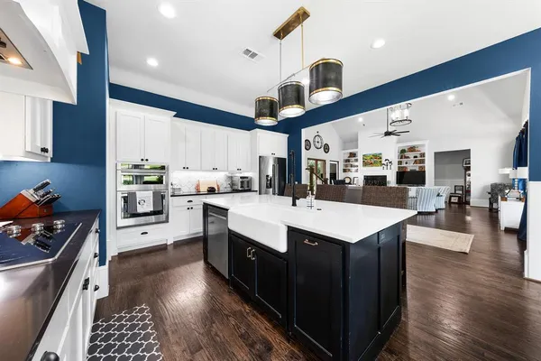a dining room with furniture a large window and a chandelier