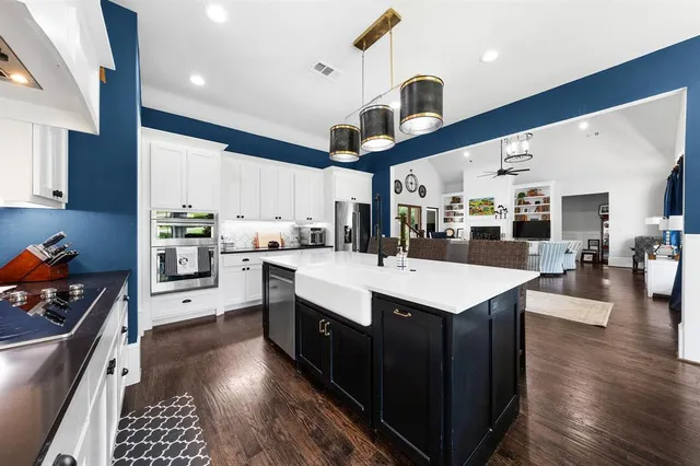 a kitchen with a stove a refrigerator and wooden cabinets