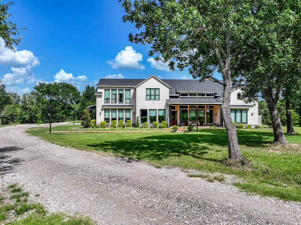 365 Private Road 5529 Point, TX 75472 - Photo 2 of 40 Modern inspired farmhouse featuring concrete driveway, a front yard, an attached garage, and brick siding