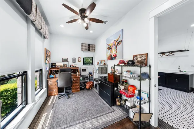 a view of a workspace with furniture and a window