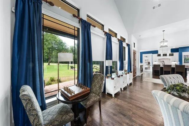 a living room with furniture a fireplace and large windows
