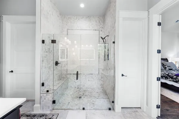 a bathroom with a double vanity sink and mirror with toilet