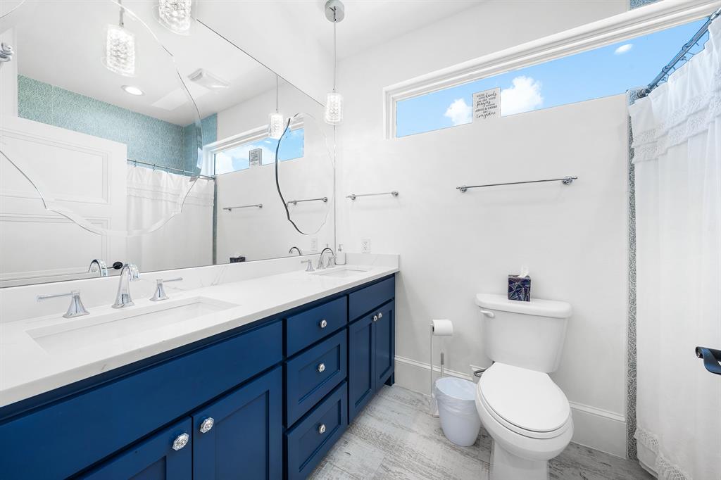 365 Private Road 5529 Point, TX 75472 - Photo 36 of 40 a bathroom with a double vanity sink and mirror with toilet