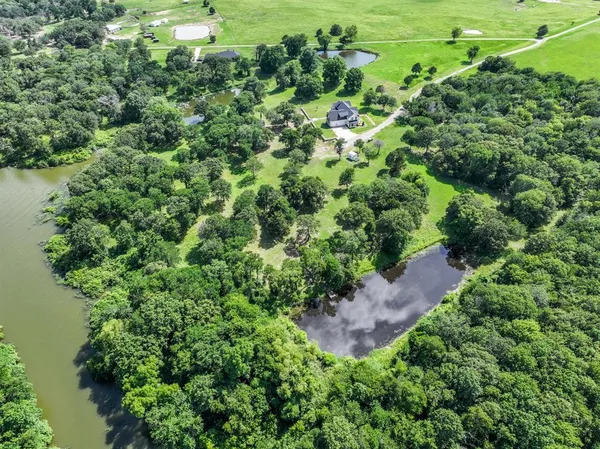 a view of a lake in middle of a forest