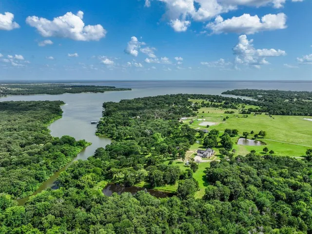 a view of a lake in middle of a forest