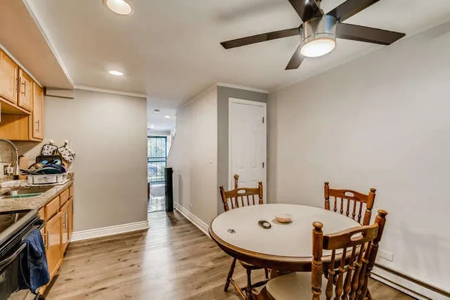 a kitchen with stainless steel appliances granite countertop a refrigerator a stove top oven a sink dishwasher and white cabinets