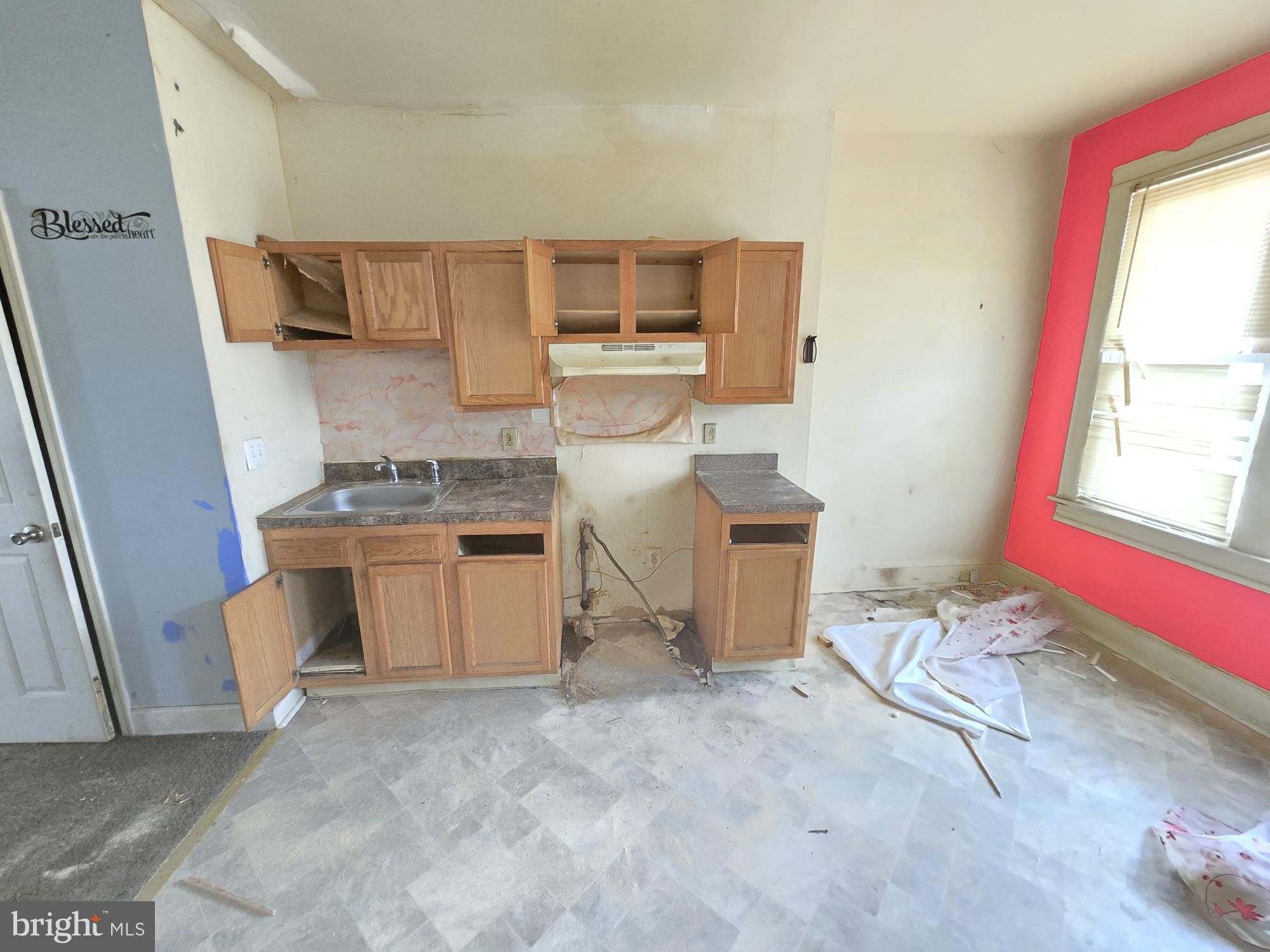653 Bartlett Avenue Baltimore, MD 21218 - Photo 6 of 14 a kitchen with a stove and a refrigerator