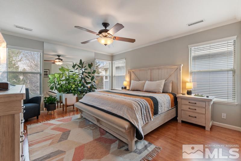 7595 Whimbleton Way Reno, NV 89511 - Photo 13 of 36 a spacious bedroom with a bed table flowerpot and a window