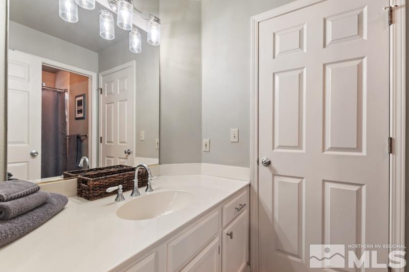 7595 Whimbleton Way Reno, NV 89511 - Photo 17 of 36 a bathroom with a sink and a mirror