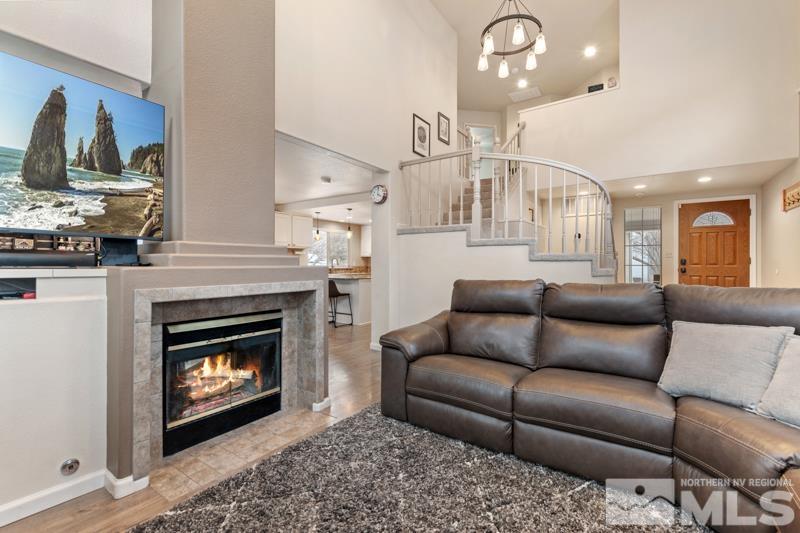 7595 Whimbleton Way Reno, NV 89511 - Photo 6 of 36 a living room with furniture a fireplace and a flat screen tv