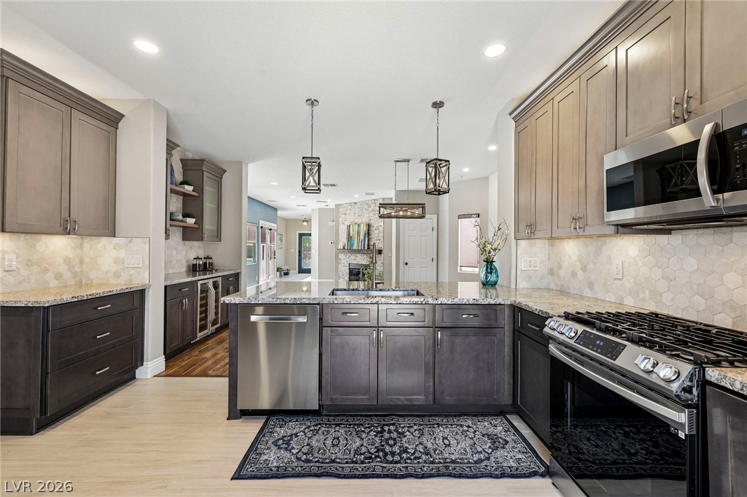 1176 Butternut Ranch Court Henderson, NV 89052 - Photo 14 of 60 Granite counters and stainless steel appliances elevate this kitchen's appeal.