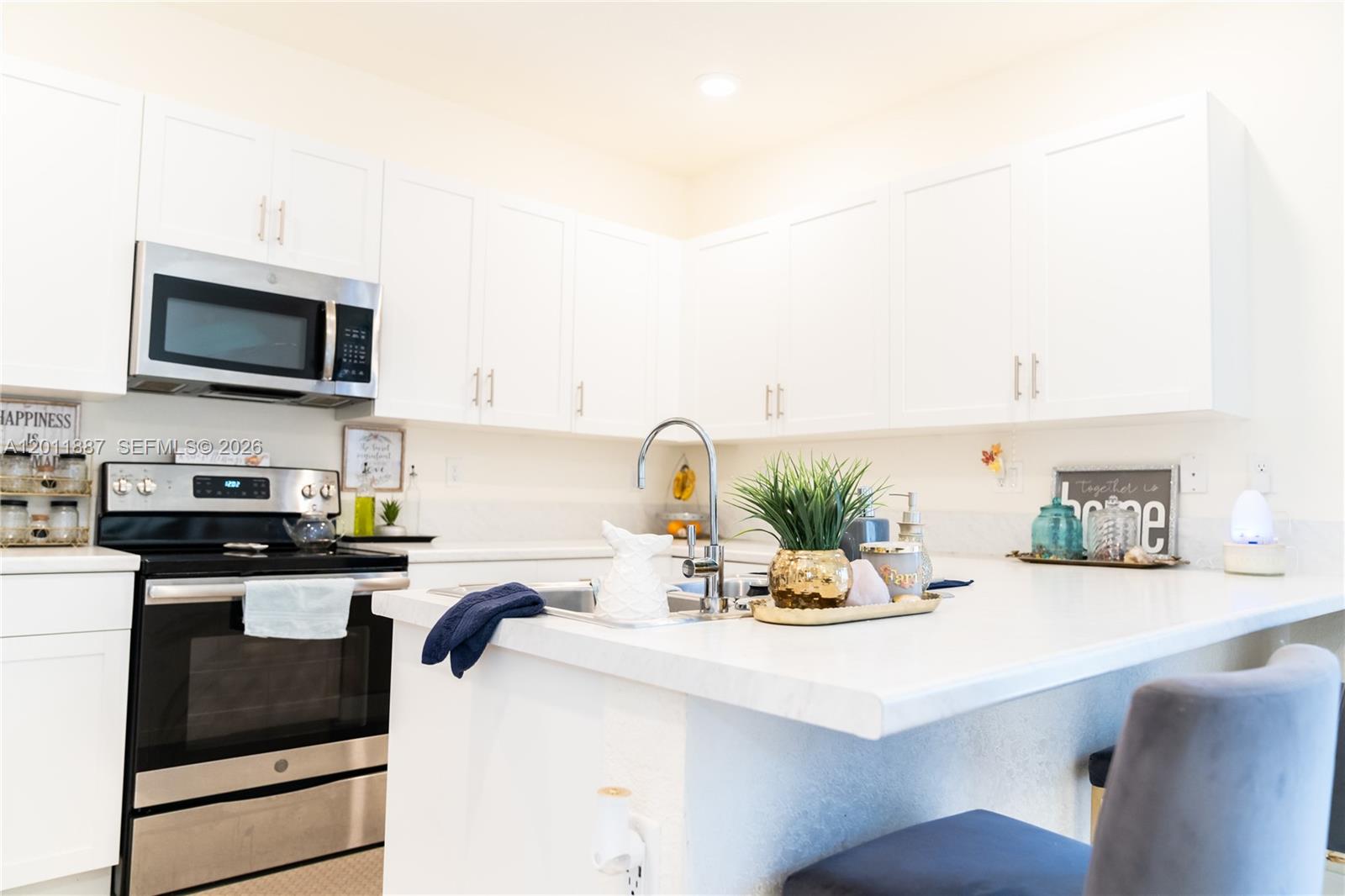 10599 West 33rd Court Hialeah, FL 33018 - Photo 13 of 39 a kitchen with kitchen island a sink appliances and cabinets
