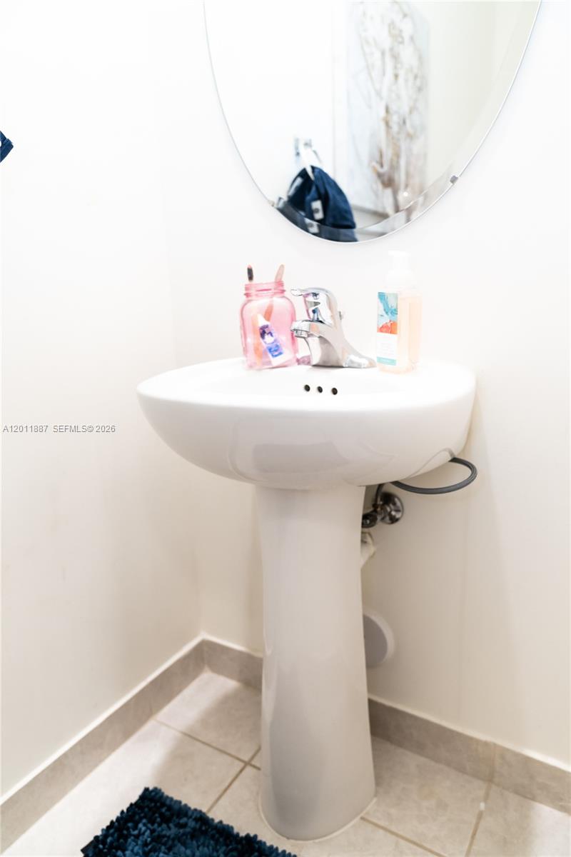 10599 West 33rd Court Hialeah, FL 33018 - Photo 15 of 39 a bathroom with a sink and a mirror