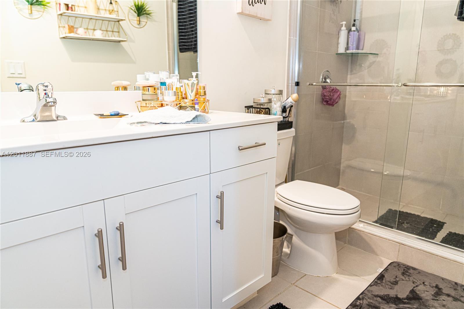 10599 West 33rd Court Hialeah, FL 33018 - Photo 19 of 39 a bathroom with a sink a toilet and shower