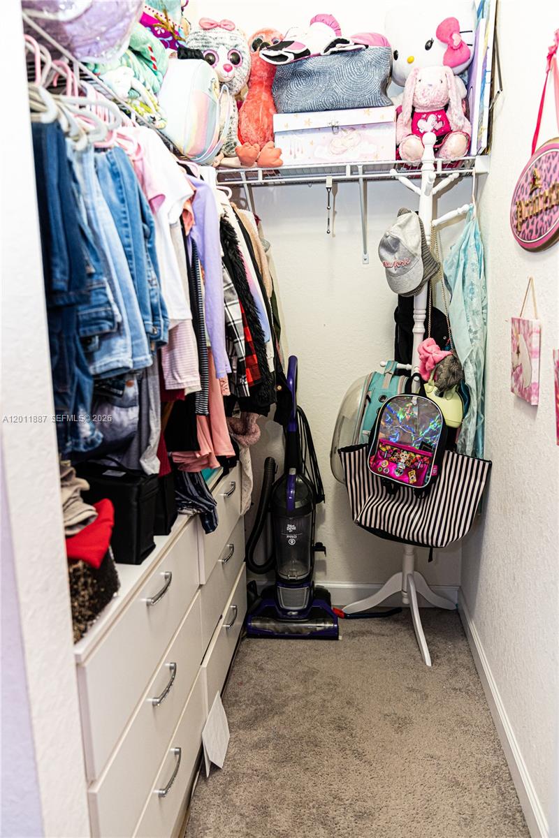 10599 West 33rd Court Hialeah, FL 33018 - Photo 20 of 39 a view of walk in closet with clothes and shoes