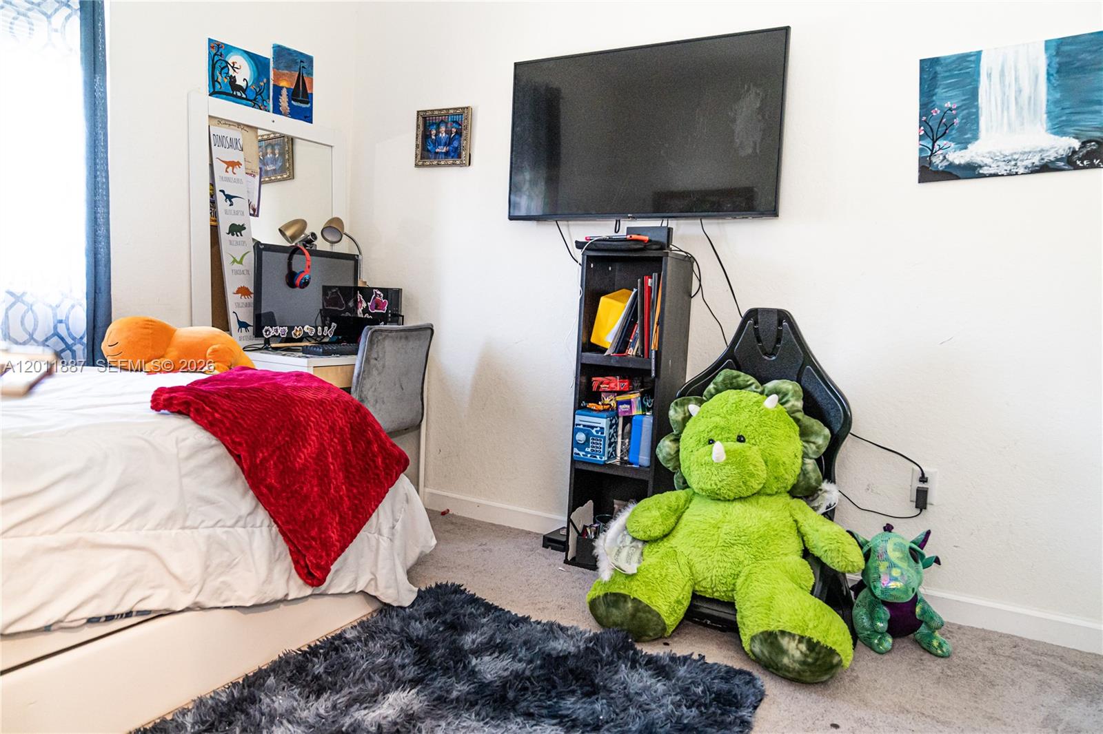 10599 West 33rd Court Hialeah, FL 33018 - Photo 23 of 39 a bedroom with a bed and a flat screen tv