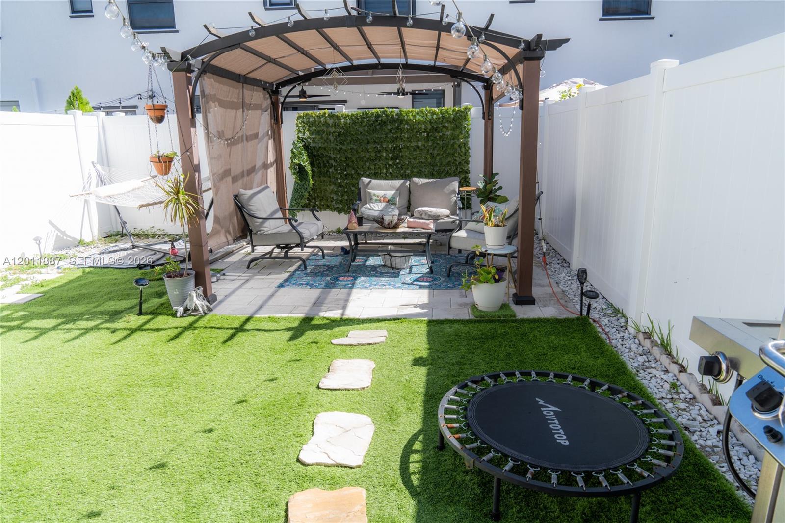 10599 West 33rd Court Hialeah, FL 33018 - Photo 28 of 39 a view of a backyard with plants and outdoor seating
