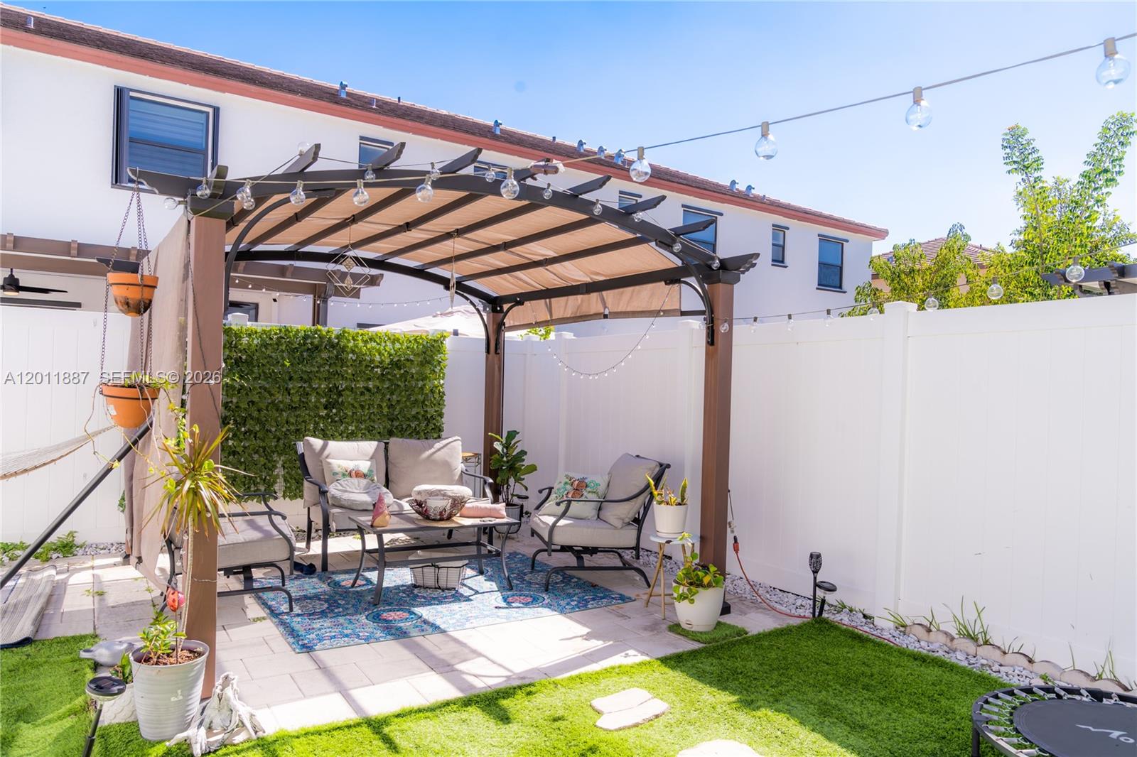 10599 West 33rd Court Hialeah, FL 33018 - Photo 29 of 39 a patio with glass top table and chairs