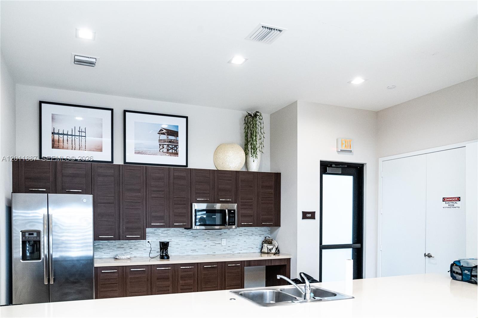 10599 West 33rd Court Hialeah, FL 33018 - Photo 33 of 39 a kitchen with stainless steel appliances kitchen island granite countertop a refrigerator and a sink