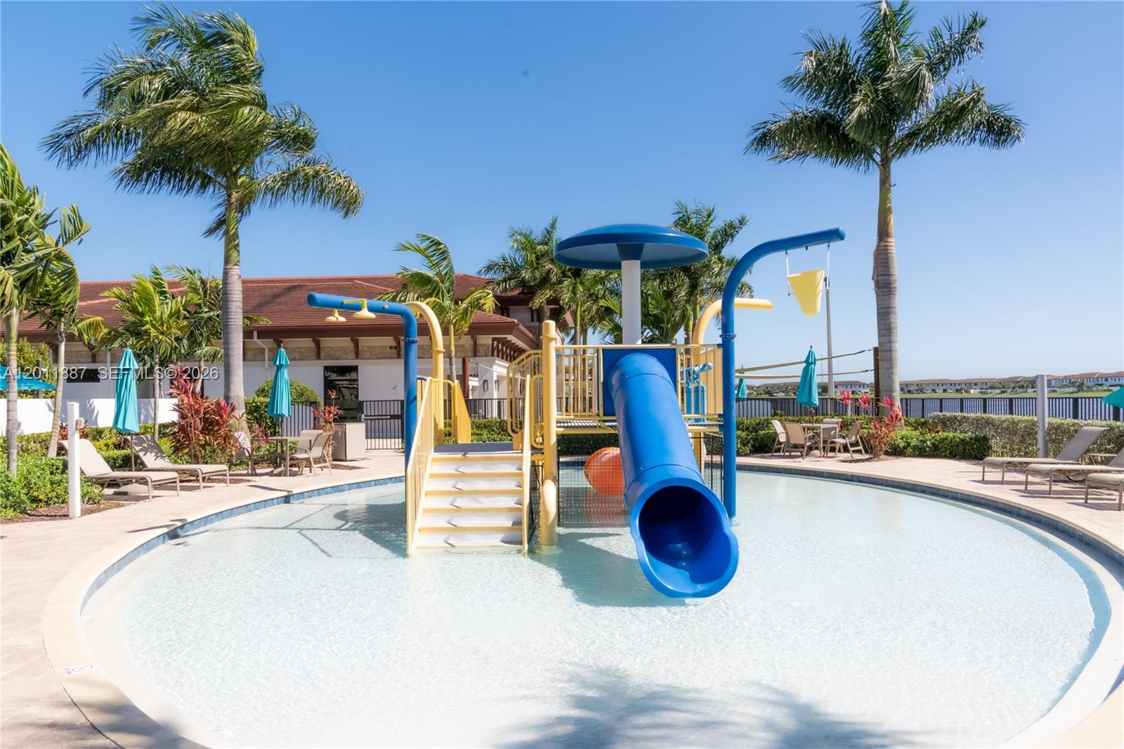 10599 West 33rd Court Hialeah, FL 33018 - Photo 36 of 39 a view of a swimming pool with a table and chairs