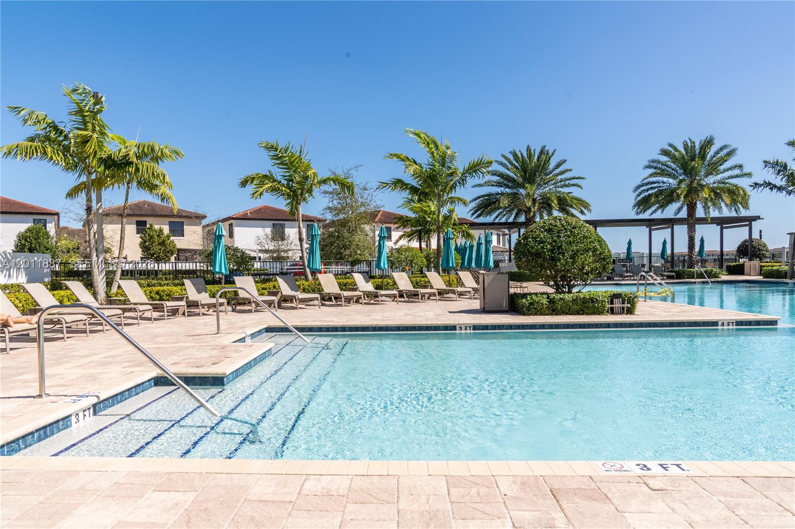 10599 West 33rd Court Hialeah, FL 33018 - Photo 37 of 39 a view of swimming pool with outdoor seating and a patio