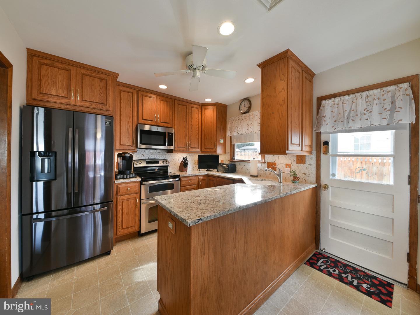 127 Ellis Road Willow Grove, PA 19090 - Photo 14 of 38 a kitchen with stainless steel appliances granite countertop a refrigerator a stove a sink and a microwave