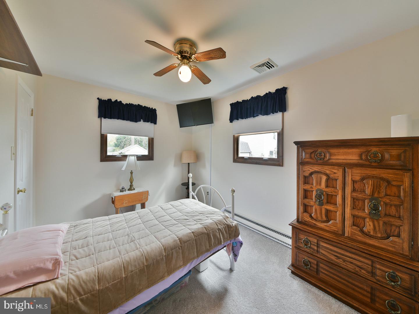 127 Ellis Road Willow Grove, PA 19090 - Photo 19 of 38 a bedroom with a large bed and a chandelier