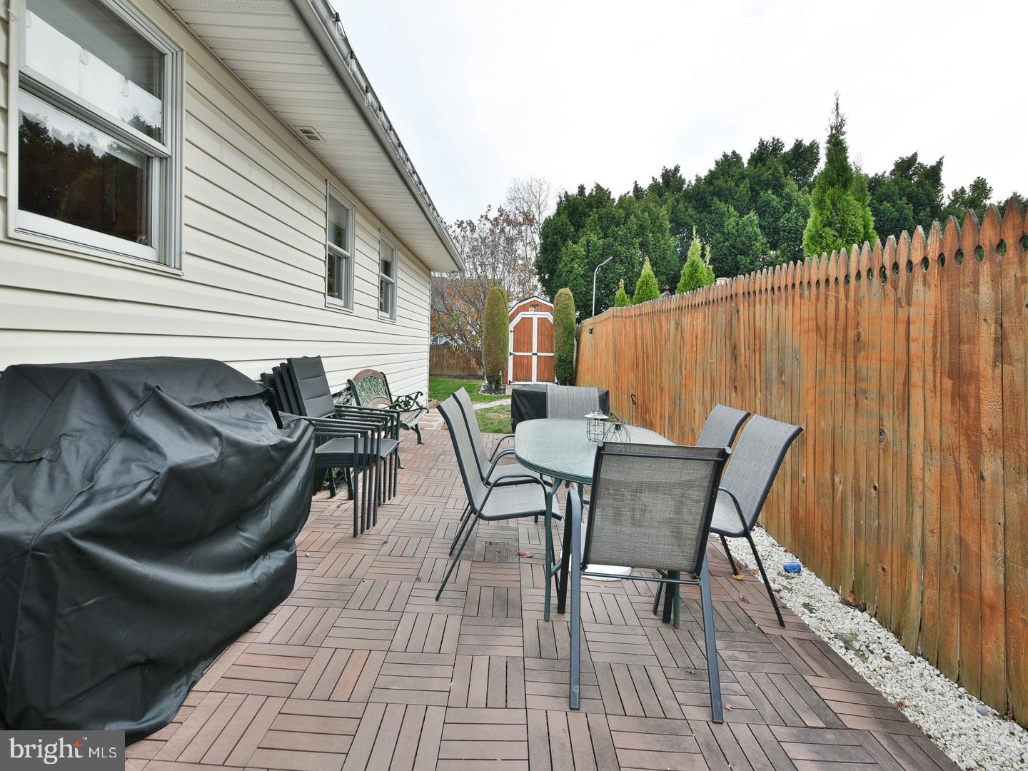 127 Ellis Road Willow Grove, PA 19090 - Photo 34 of 38 a view of a patio with table and chairs with wooden floor and fence