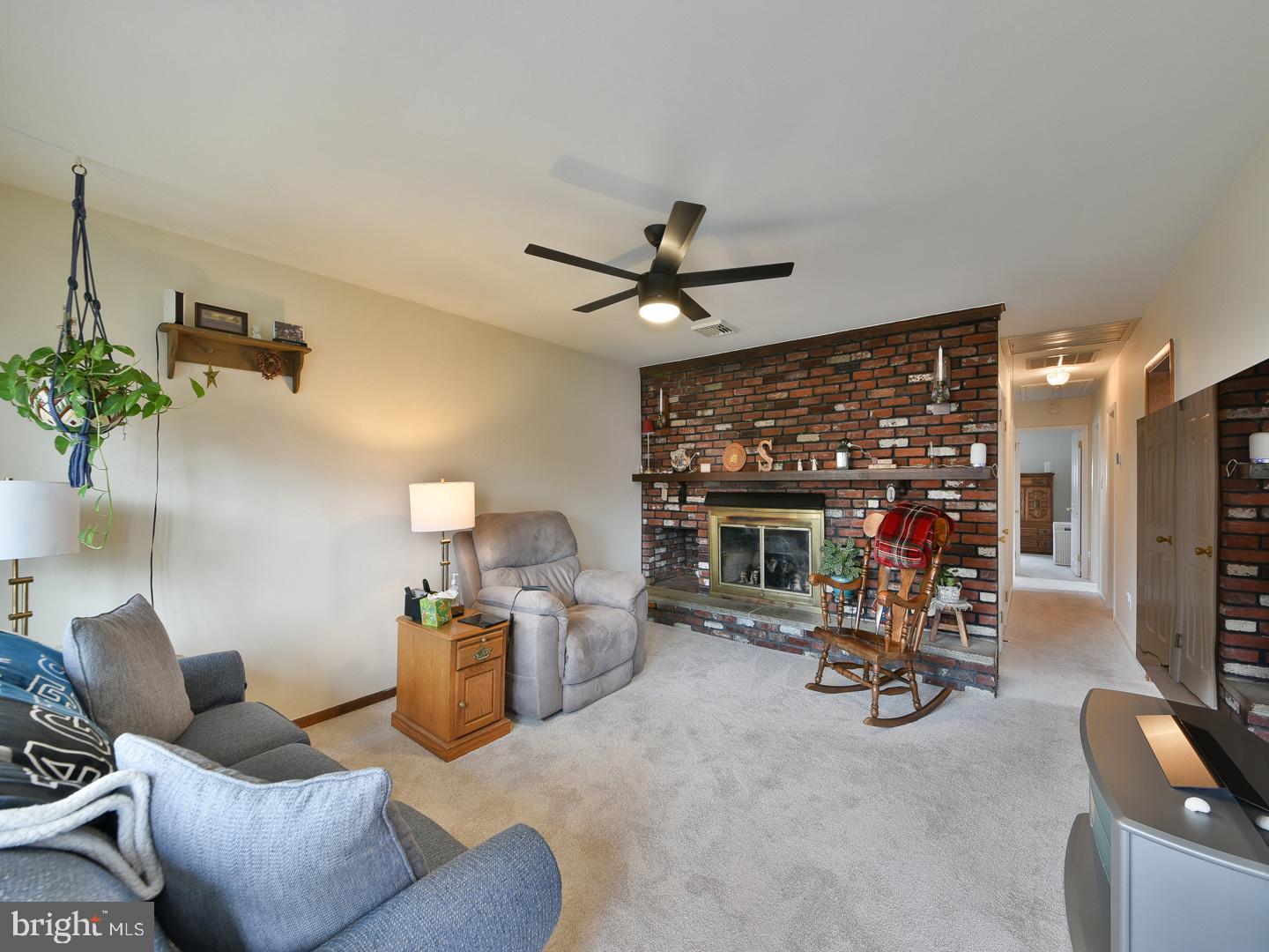 127 Ellis Road Willow Grove, PA 19090 - Photo 7 of 38 a living room with furniture a fireplace and a flat screen tv