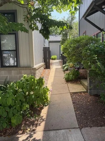 a front view of a house with a yard and potted plants