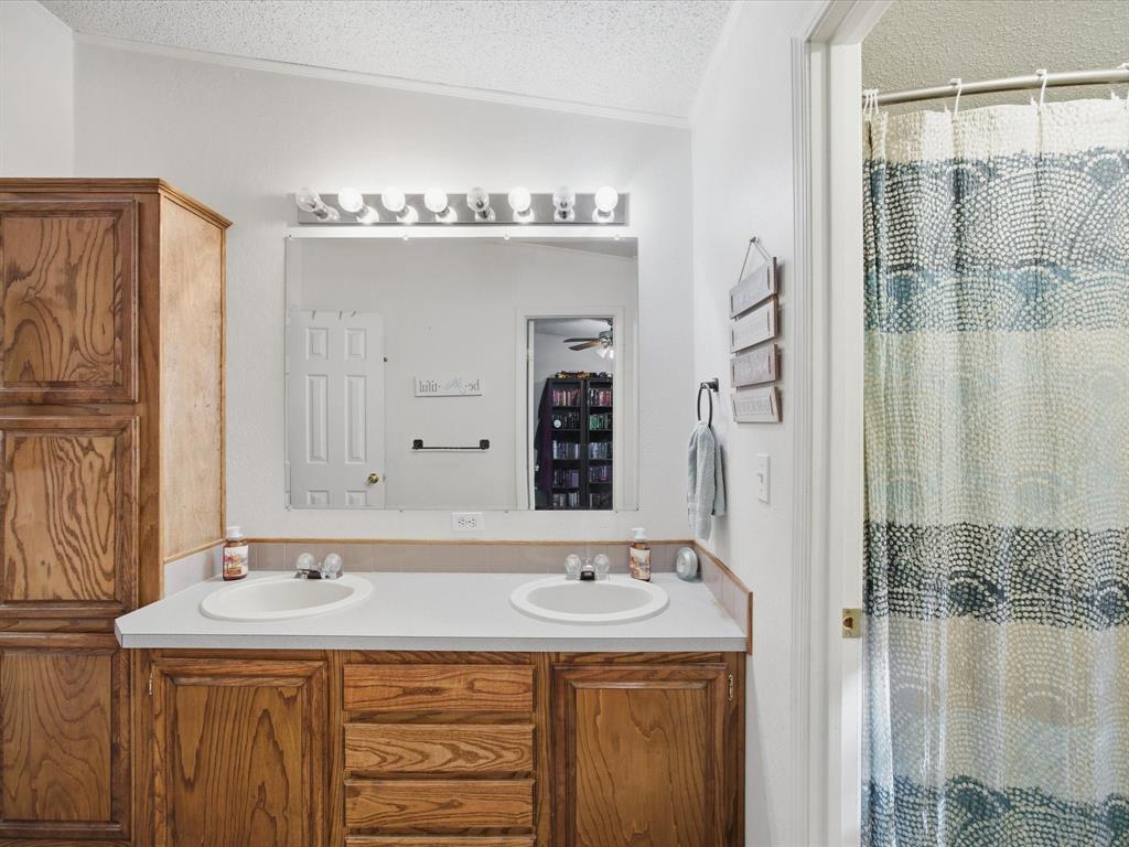 3275 Finis Road Graham, TX 76450 - Photo 22 of 36 a bathroom with a sink and a mirror