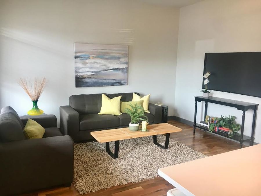 Undisclosed Address Chicago, IL 60657 - Photo 3 of 8 a living room with furniture and a flat screen tv