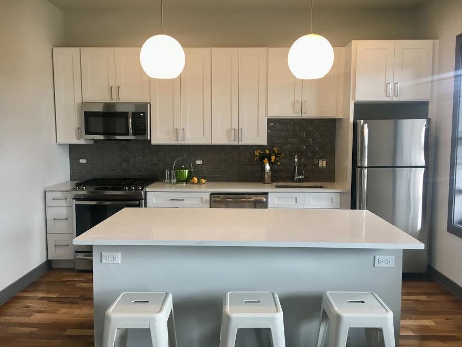Undisclosed Address Chicago, IL 60657 - Photo 4 of 8 a kitchen with stainless steel appliances a sink a stove a refrigerator a microwave a counter top and cabinets