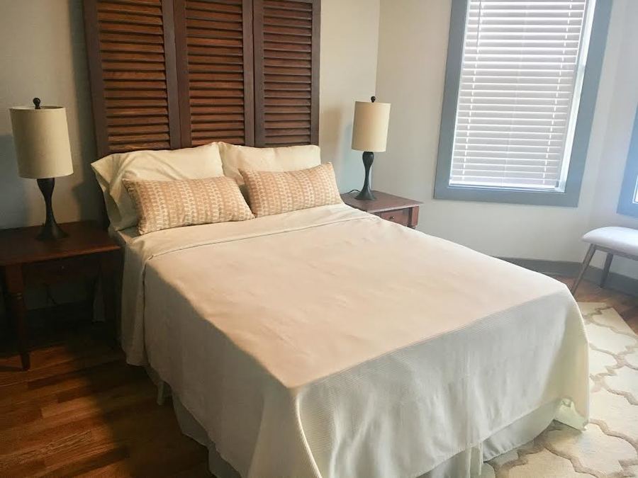 Undisclosed Address Chicago, IL 60657 - Photo 6 of 8 a bedroom with a bed and a lamp