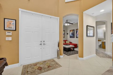 a view of a patio with table and chairs under an umbrella