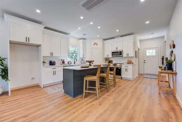a kitchen with cabinets a sink and appliances