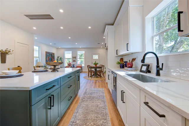 a kitchen that has a sink and a stove