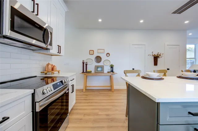 a stove top oven sitting inside of a kitchen