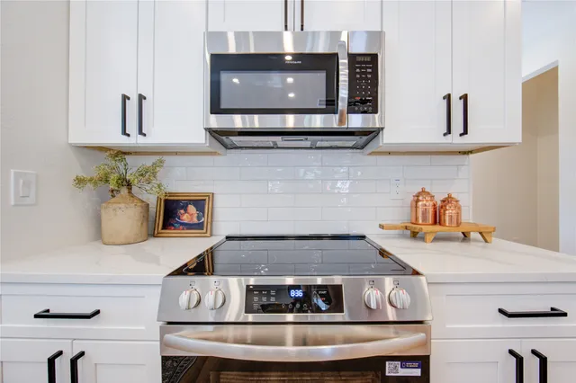 a kitchen that has a sink and a stove in it